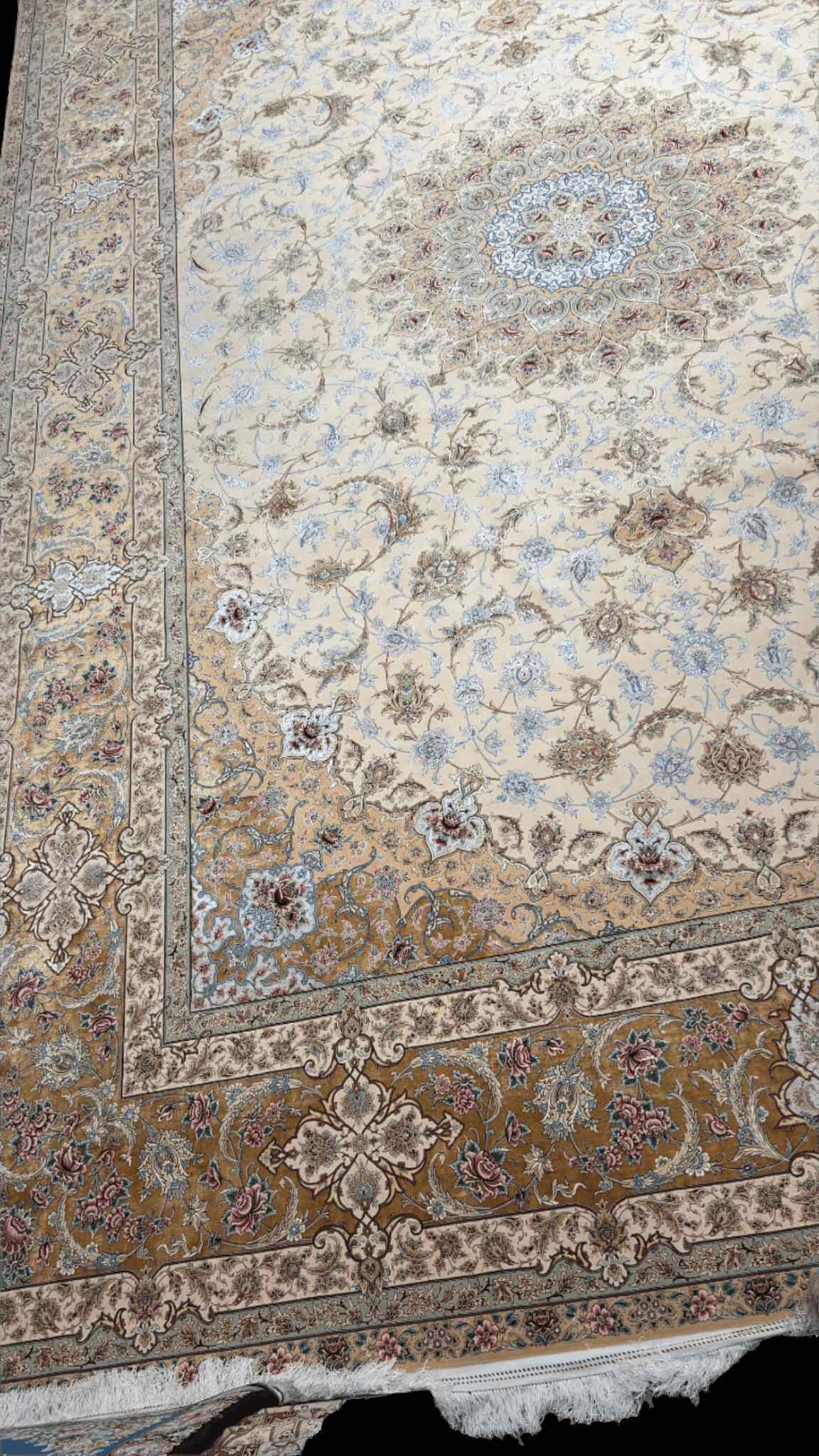 "Luxurious wool and silk Persian rug with intricate floral design in cream and gold tones."